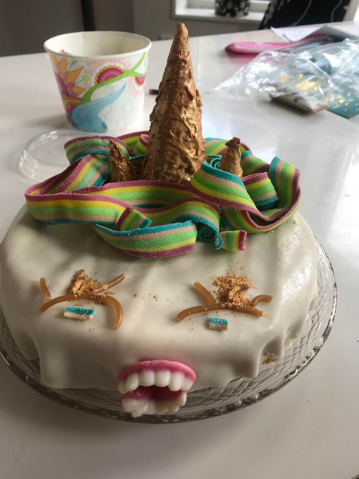 Homemade unicorn cake with fondant, rainbow candy mane and joke teeth
